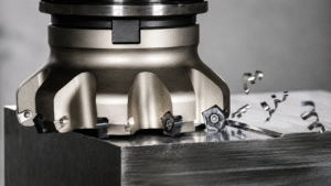 CNC milling machine cutting a metal component on a machining center